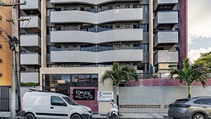 A multi-story building with a modern architectural design, featuring balconies and large windows. - Cozy Studio 376m From the Beach - Ere418 (Maceió)