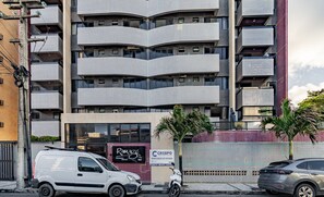 A multi-story building with a modern architectural design, featuring balconies and large windows. - Cozy Studio 376m From the Beach - Ere418 (Maceió)