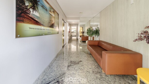A hallway with a marble floor, a brown leather sofa, a yellow chair, and a poster of a beach scene. - Apart w/ Pool 450m From the Beach, Maceio Eez0301 (Maceió)