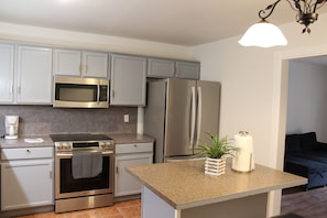 A kitchen with stainless steel appliances, a countertop, and cabinets. - Spacious 4BR/2BA Near Amazing Restaurants, Alamo, Riverwalk, Missions & Downtown (San Antonio)