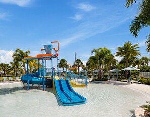 A water park with a blue slide and a water play area. - Orlando Adventure Awaits 4BR Townhouse (Kissimmee)
