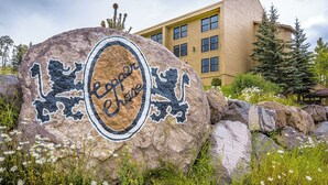 A large rock with the text "Capitol Cove" and a building in the background. - Copper Chase 116 (Brian Head)