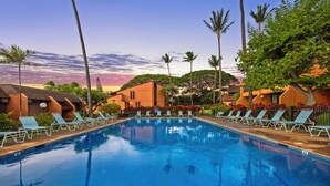 A swimming pool with lounge chairs and palm trees. - Kuleana Club - 307 (Lahaina)