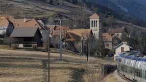 A rural village with traditional houses, a church, and a train track. - House in a quiet mountain village (Lus La Croix haute)