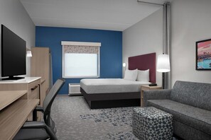 Ropa de cama hipoalergénica y caja de seguridad en la habitación 