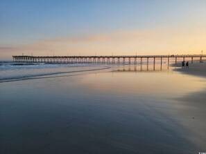 A beach with a pier extending into the water. - Chic Boho 4BR Retreat w/ Doggie by Beach&Golf+BBQ (Sunset Beach)