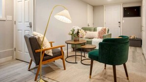 A living room with a sofa, two chairs, a coffee table, and a floor lamp. - Modern Cozy Bright 2BR Lower Unit w/private entry (Seattle)