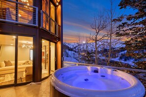 A modern building with a hot tub on a balcony overlooking a snowy landscape. - Enjoy pure luxury in Alta in this Contemporary Condominium with Hot Tub (Alta)