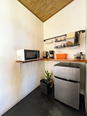 Fridge, microwave, coffee/tea maker, cookware/dishes/utensils