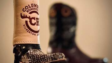 A pair of cowboy boots with a leather boot and a metal shank, and a leather boot with a metal shank.