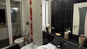 A modern bathroom with two sinks, a large mirror, and a glass-enclosed shower area. - Cozy 2-bedroom apartment in center Durres (durres)