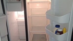 An open refrigerator with multiple shelves and a freezer compartment. - 10 min. from the beach, pet-friendly, fenced yard. (Englewood)