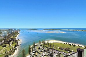 A coastal view with a marina, beach, and residential area.
