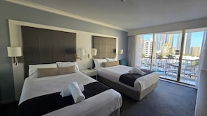 Desk, iron/ironing board, bed sheets