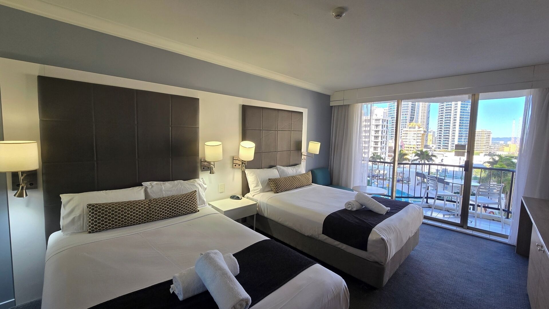 Desk, iron/ironing board, bed sheets