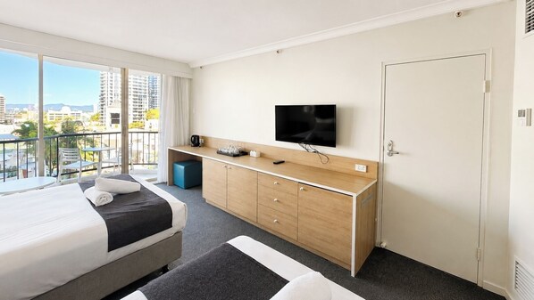 Desk, iron/ironing board, bed sheets