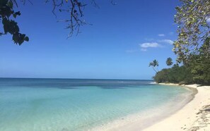 A beach with clear turquoise water, white sand, and lush greenery. - Full house with prívate Swimming Pool (Cabo Rojo)