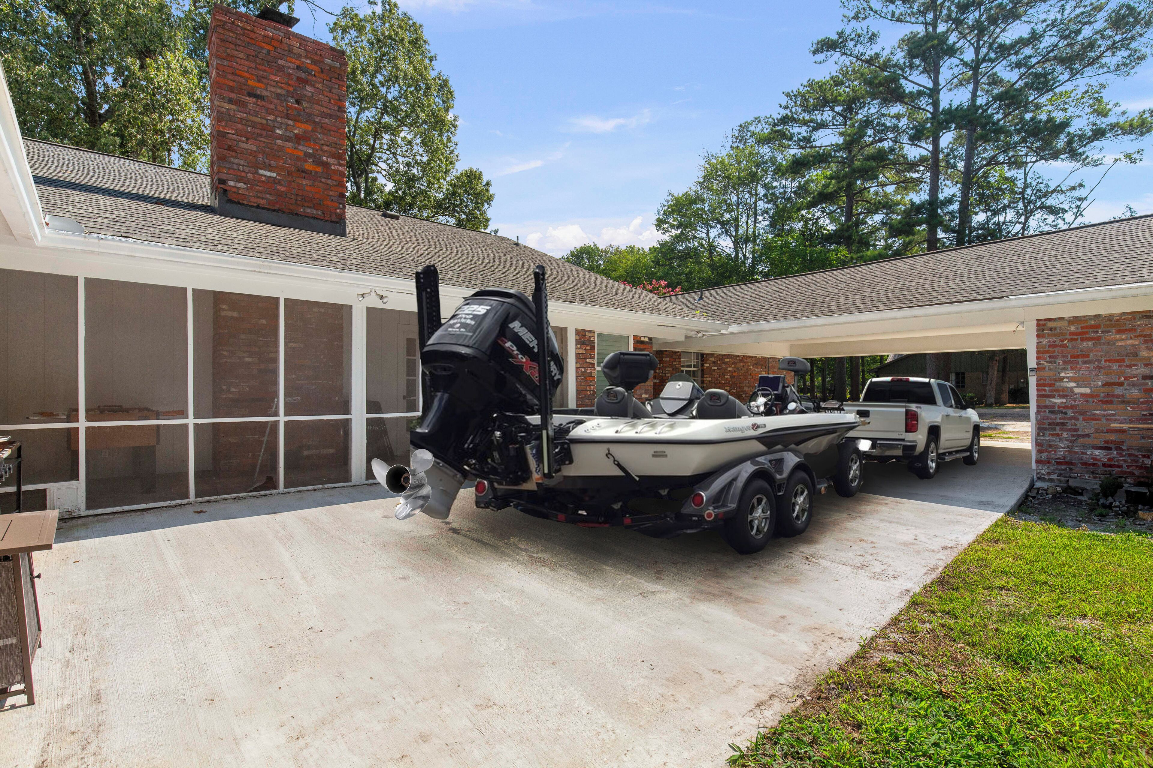 A garage with a boat trailer and a truck parked inside.