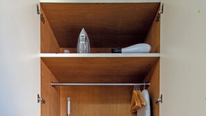 A compact storage unit with shelves, a hanging rack, and a metal rack.