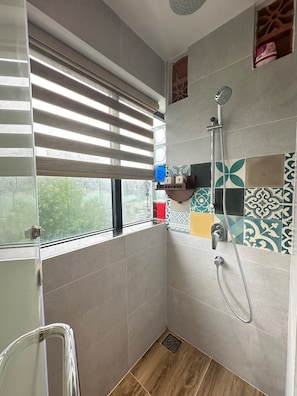 Shower, rainfall showerhead, slippers, towels