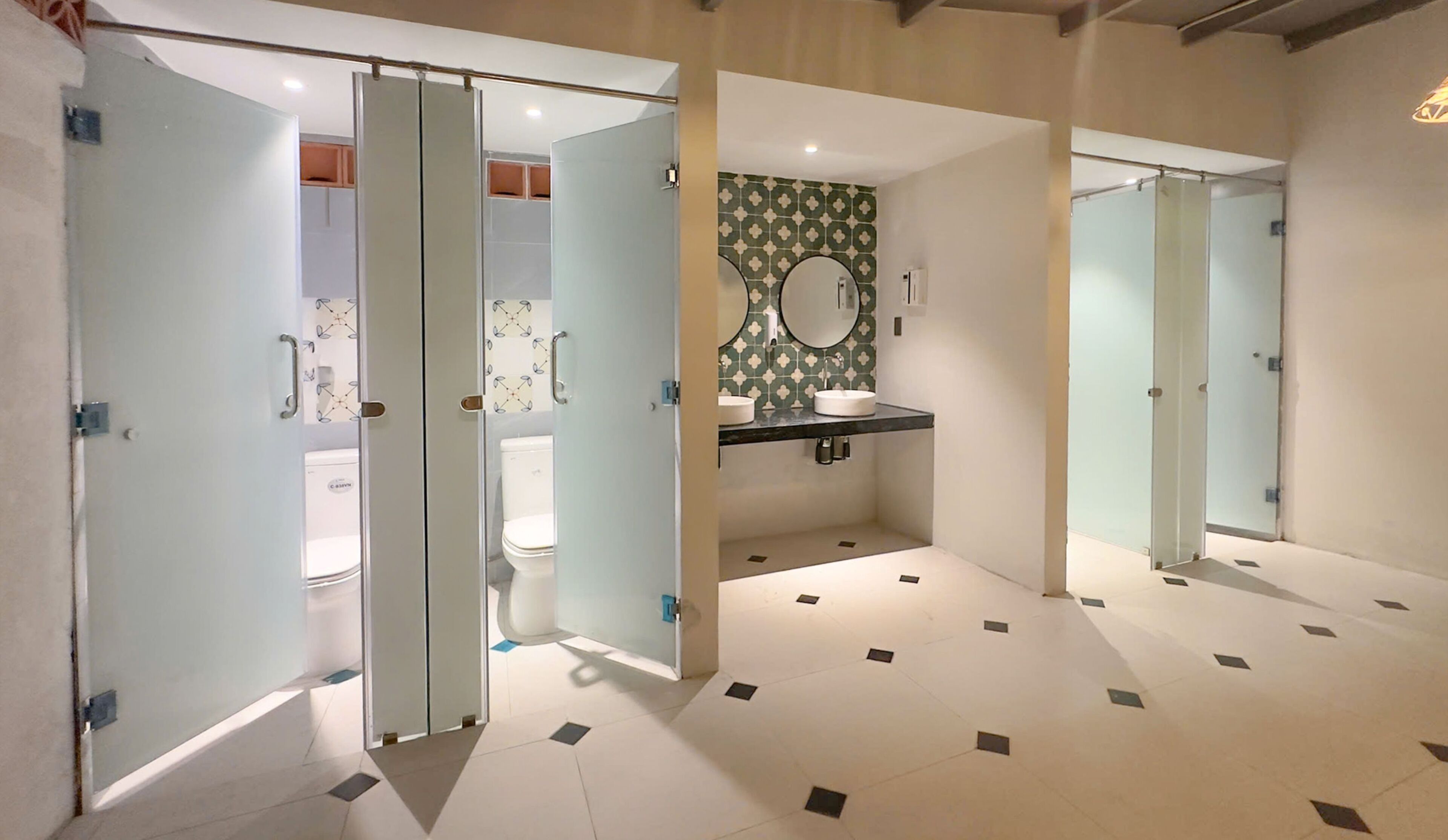 A modern bathroom with a toilet, bidet, and sink.
