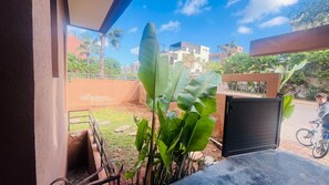 A balcony with a view of a cityscape, a bicycle, and a black gate. - Romantic villa with pool and waterfront. (Casablanca)