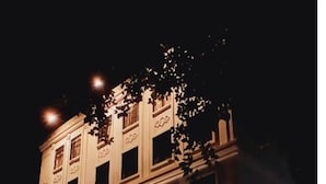 A building with a classical architectural style, featuring a symmetrical facade with evenly spaced windows and decorative elements. - Hotel Goldenkey (Kolkata)