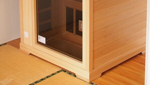 A wooden sauna with a sliding door and a control panel on the left. - FURANO RELAX STAY A (Furano)