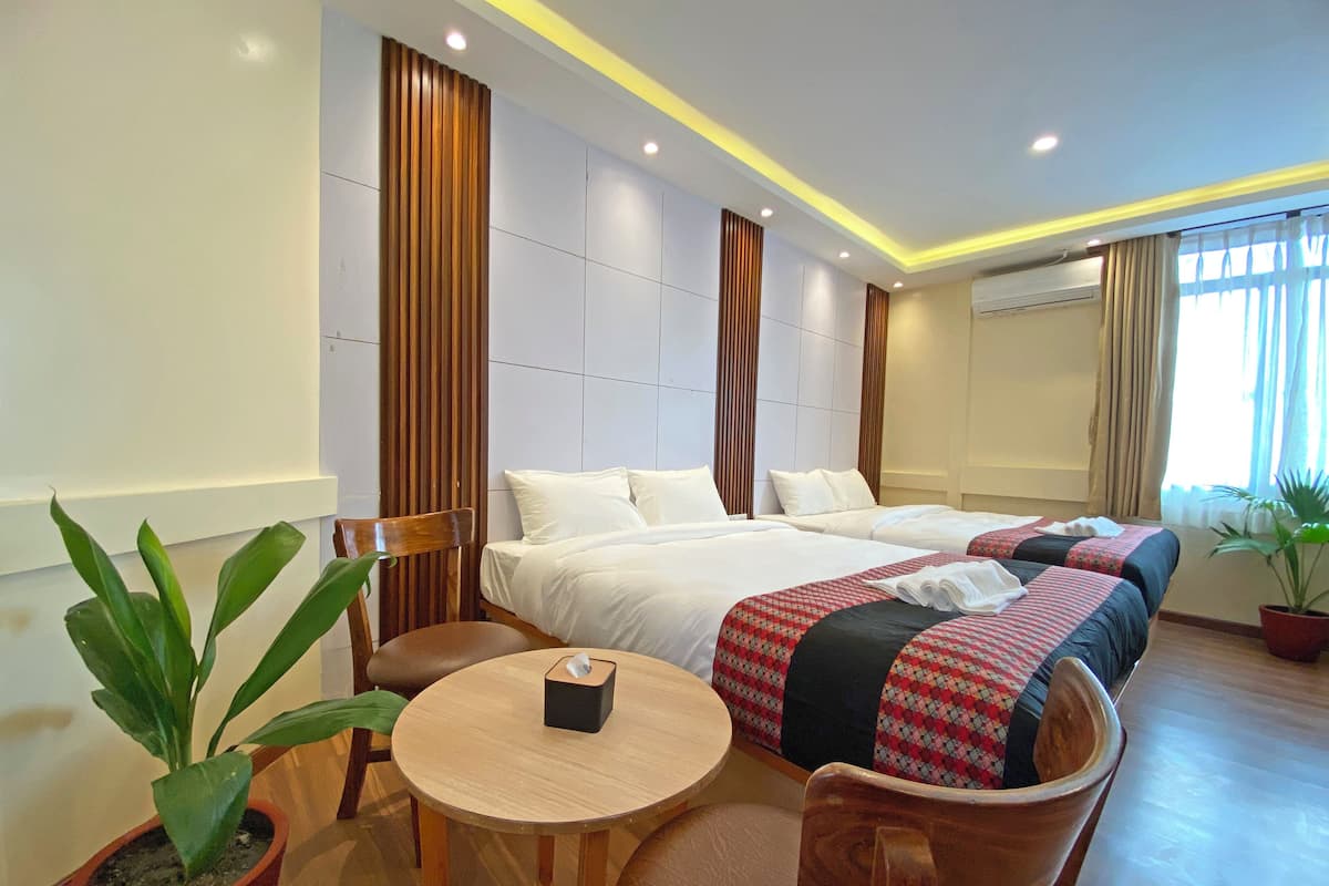 Deluxe Quadruple Room, City View | Desk, laptop workspace, free WiFi