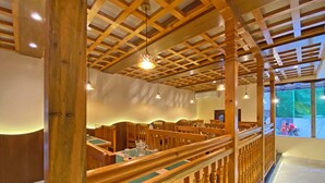 A wooden interior with a high ceiling, wooden benches, and a glass railing. - Hotel Insta (Kathmandu)