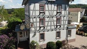 A traditional half-timbered building with multiple windows and a sign indicating it is a restaurant. - Birkenfelder Hof  (Birkenfeld)