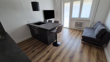 Departamento Deluxe, balcón | Área de sala de estar