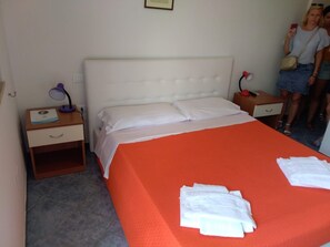 A hotel room with a large bed, two bedside tables, a nightstand, and a lamp. - Exclusive Flats inside 4 Stars Resort (Laura)