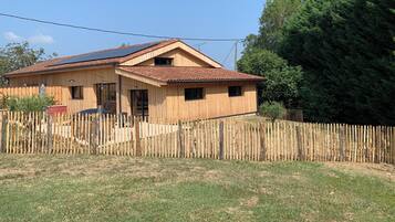 Ein Holzhaus mit geneigtem Dach und Solaranlage.