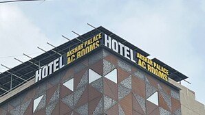 A building with a geometric facade and signage for "Hotel Akshar Palace AC Rooms". - Hotel Akshar Palace (Vadodara)