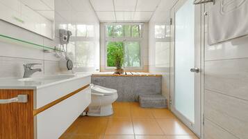 Un baño moderno con inodoro, lavabo y ventana.