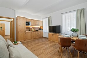 Family Apartment, 1 Queen Bed with Sofa bed | Living room | 50-inch flat-screen TV with digital channels