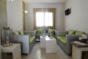 A modern living room with a sofa set, a coffee table, and decorative lanterns.