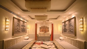 A hotel room with a central area featuring a sink and mirror, flanked by two benches.