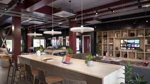 A modern interior with a long wooden bar, multiple seating areas, and a television displaying various channels. - Student Only Exchange Court (Leeds)