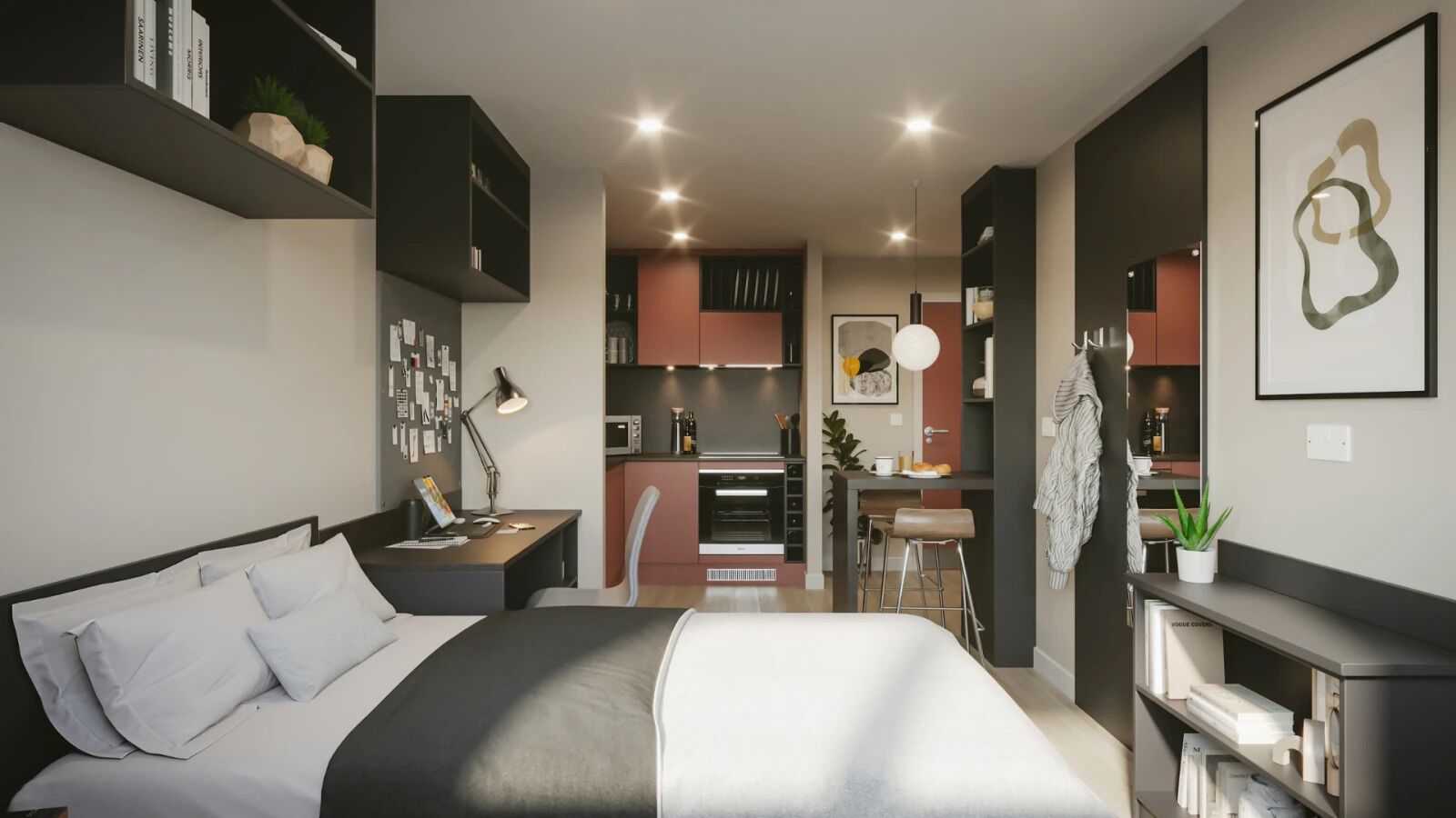 Une chambre d’hôtel moderne dotée d’un grand lit, d’un bureau, d’une kitchenette et d’un petit coin repas.