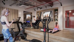 A gym with exercise equipment, a treadmill, and a seated exercise machine. - Student Only Exchange Court (Leeds)