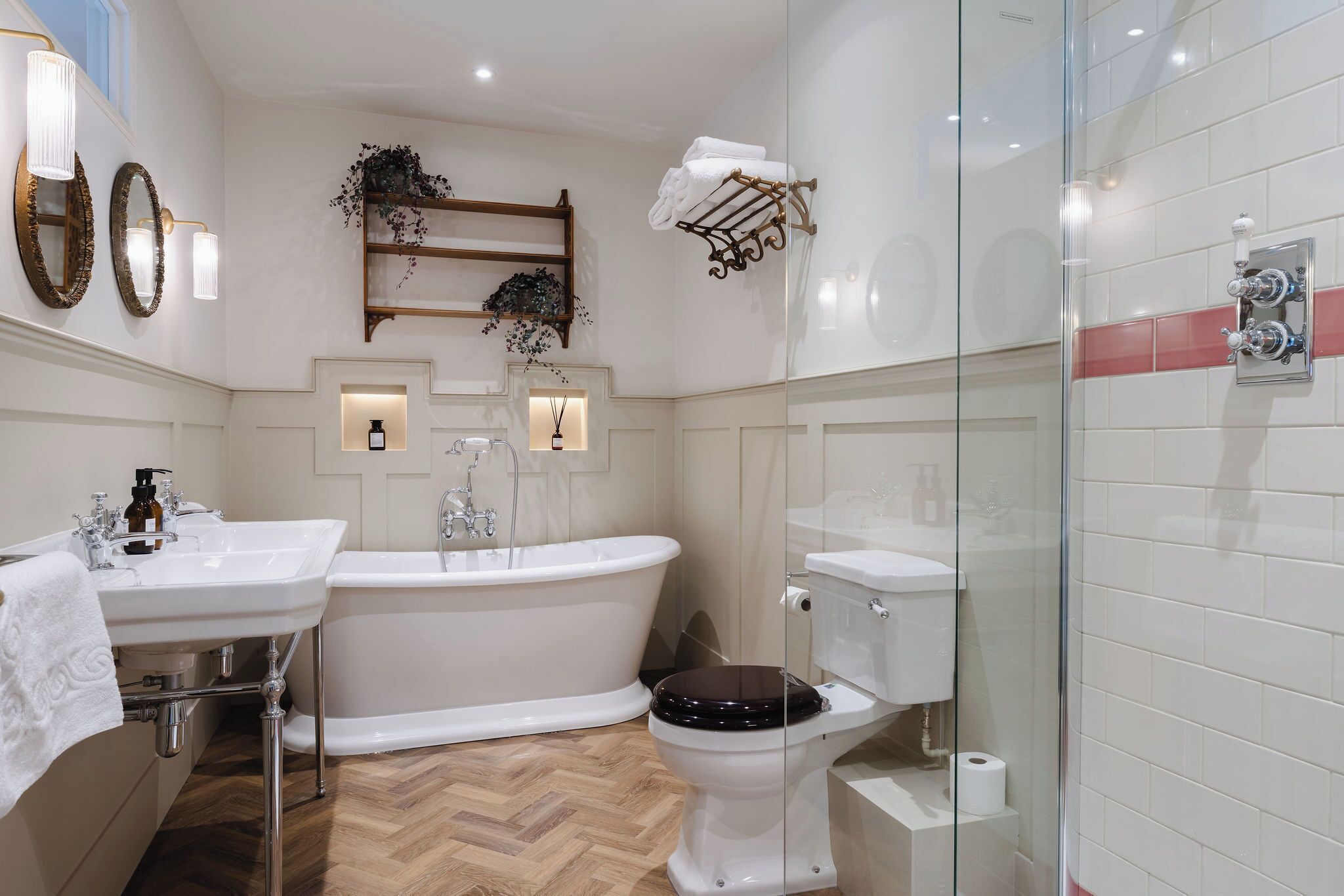 A bathroom with a freestanding bathtub, a toilet, and a glass-enclosed shower area.