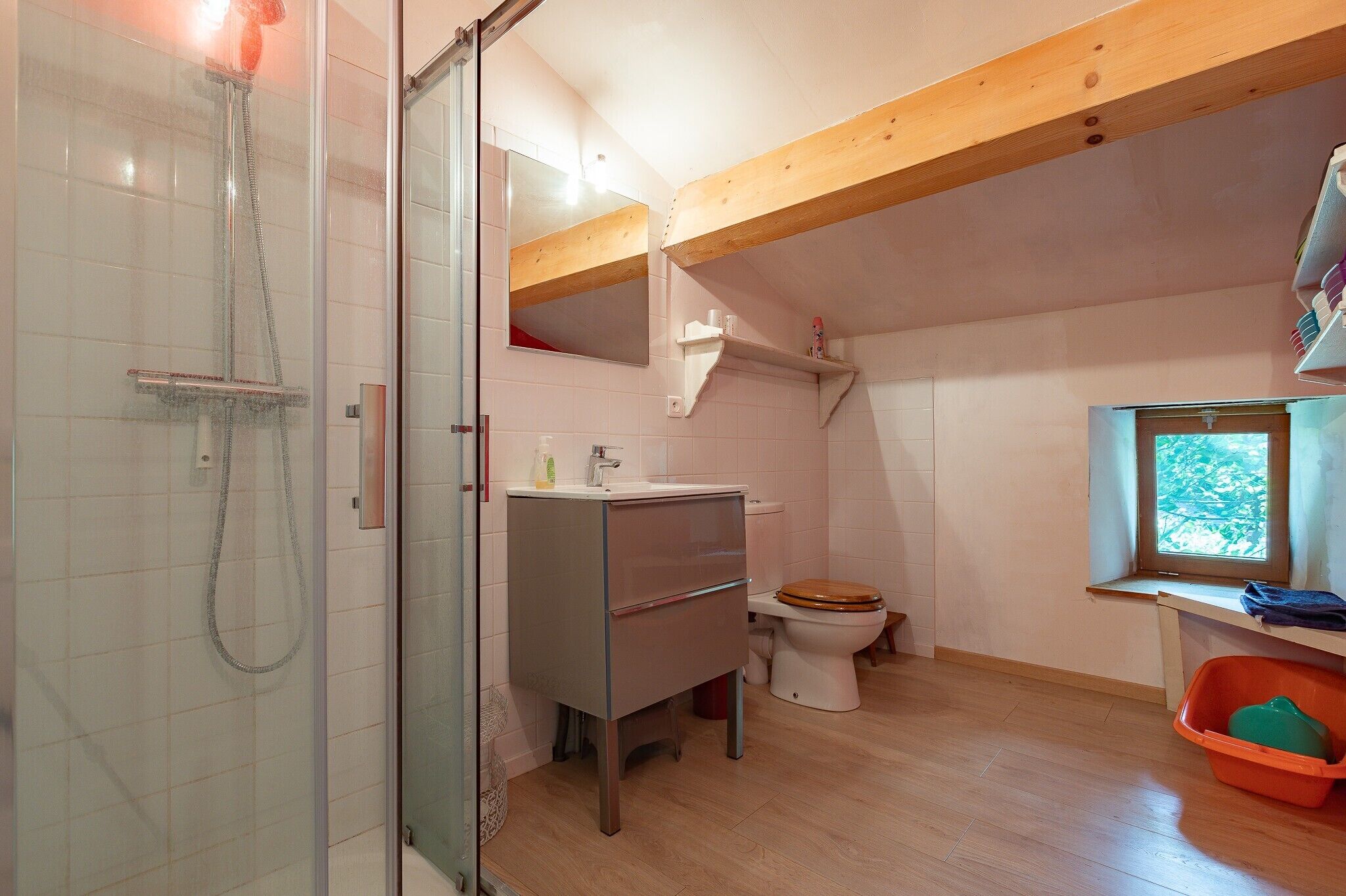 A bathroom with a shower, toilet, and sink.