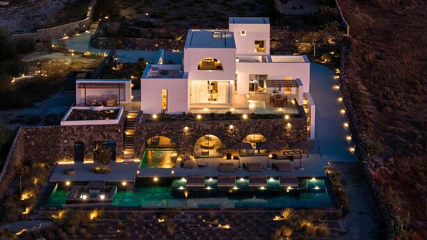 A modern villa with a swimming pool, outdoor seating, and a stone pathway leading to the entrance. - Villa Kallisti with private pool - My Rental Homes (Ia)