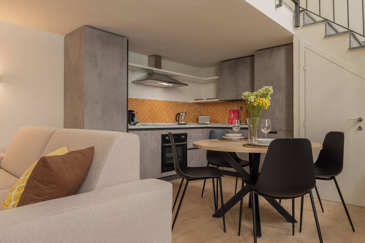 A modern kitchen with a dining area.