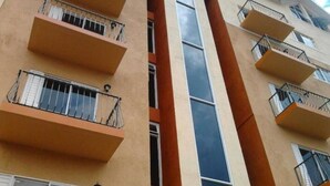 A multi-story building with balconies and windows.