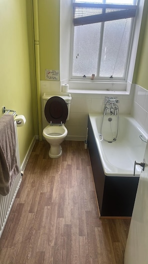 Separate tub and shower, towels, soap, shampoo
