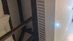 A high ceiling with exposed wooden beams and white railings. - New Apartment - Sleeps 4 - Parking - City Centre (Bradford)