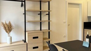 A modern room with a black metal shelving unit, a wooden desk, and a chair. - Lovely 2-bedroom apartment with terrace & parking (Izola)